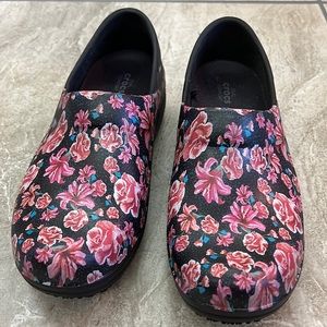 Crocs healthcare worker clogs. Cute floral decoration on navy background